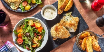 Cheesy Garlic Chicken Kievs with Rosemary Wedges, Baby Leaf and Tomato Salad Recipe