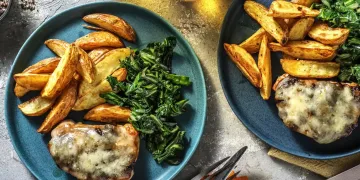 Cheese and Caramelised Onion Pork Steaks with Wedges and Garlicky Greens